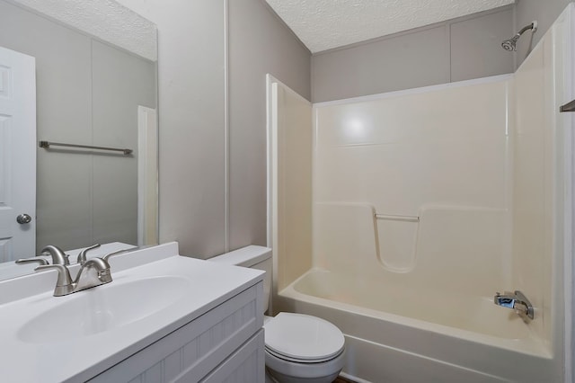 full bathroom featuring toilet, bathtub / shower combination, a textured ceiling, and vanity