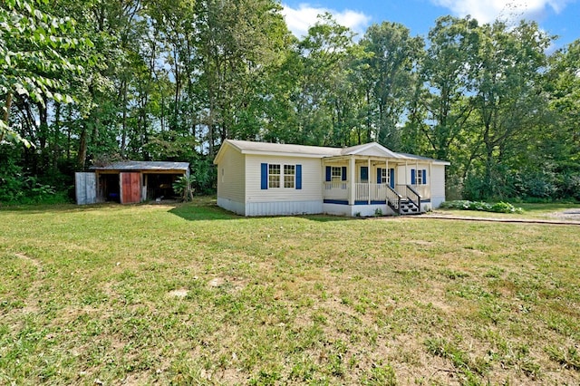 manufactured / mobile home with an outdoor structure, a porch, and a front yard