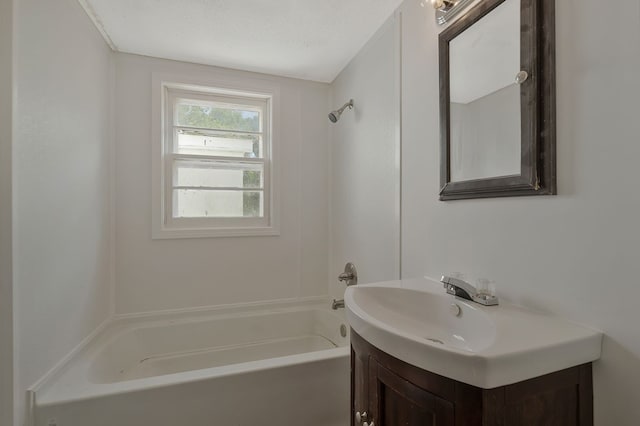 bathroom featuring  shower combination, a textured ceiling, and vanity