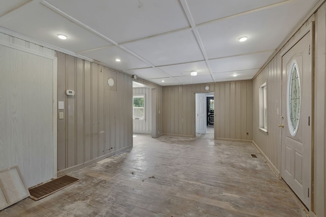 foyer entrance featuring light wood-style floors, baseboards, and visible vents