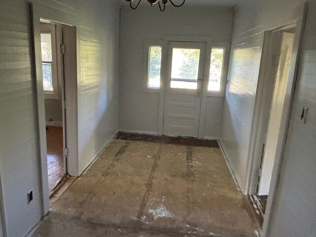 doorway to outside with a chandelier