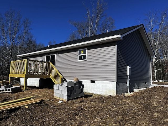 view of home's exterior with crawl space and a deck