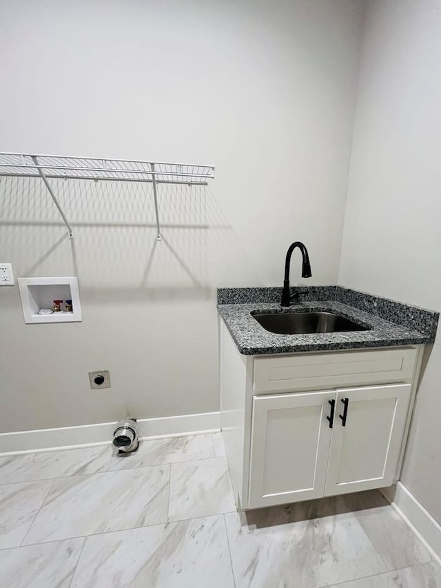 clothes washing area with marble finish floor, hookup for a washing machine, hookup for an electric dryer, a sink, and baseboards