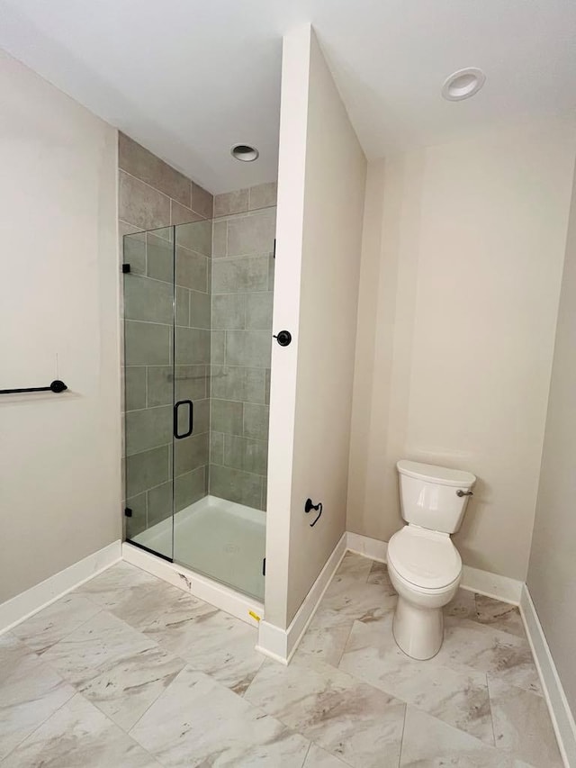 full bathroom with marble finish floor, baseboards, a shower stall, and toilet