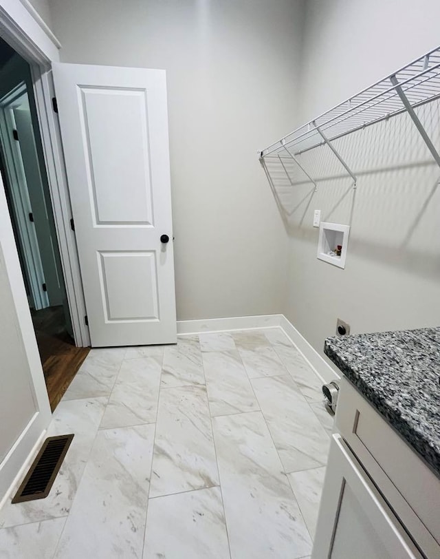 washroom with marble finish floor, hookup for a washing machine, visible vents, electric dryer hookup, and baseboards