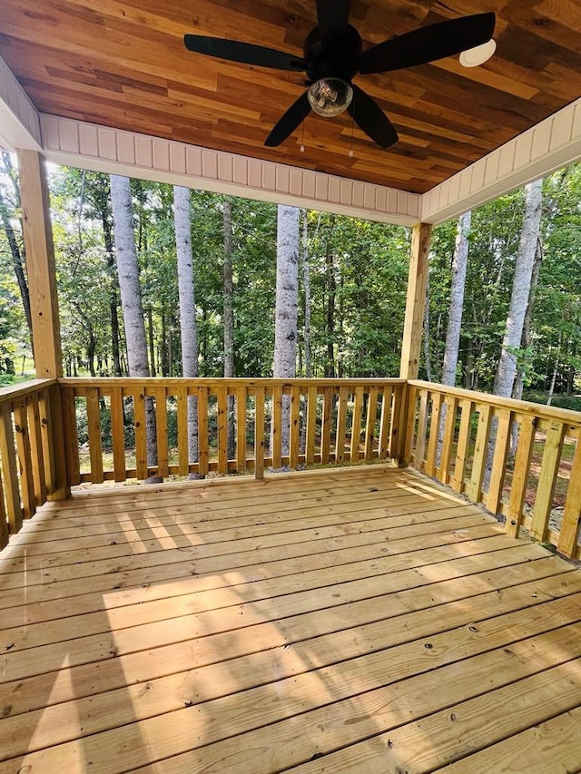 wooden terrace featuring ceiling fan