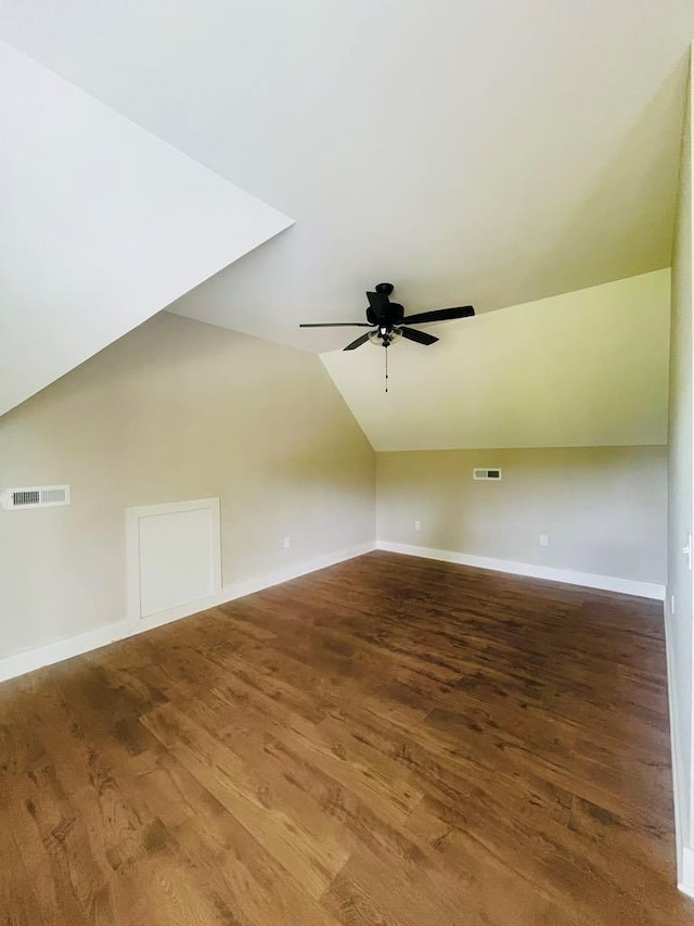 additional living space featuring lofted ceiling, visible vents, baseboards, and wood finished floors