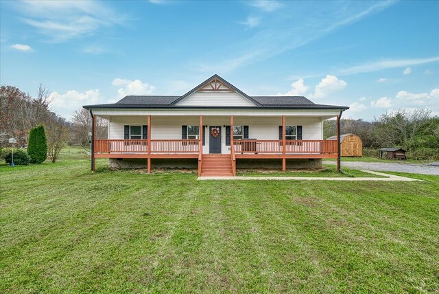 view of front facade featuring a shed, a front lawn, and an outbuilding