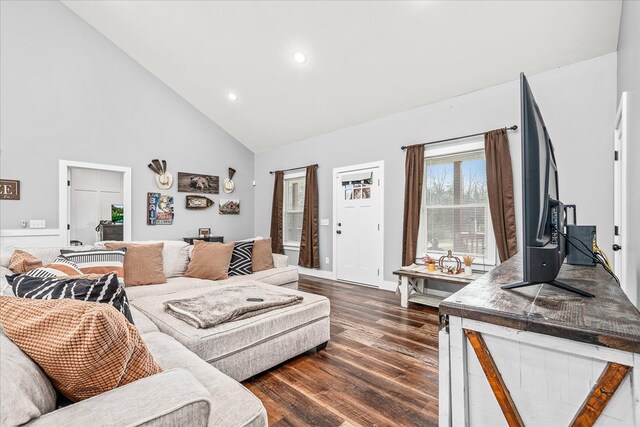 living room with dark wood-style floors, high vaulted ceiling, and recessed lighting