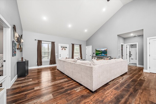 living area featuring high vaulted ceiling, dark wood-type flooring, recessed lighting, and baseboards