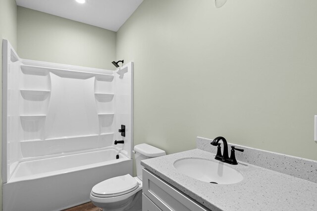 bathroom with bathtub / shower combination, vanity, and toilet