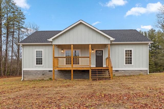 view of front of property featuring board and batten siding, crawl space, covered porch, and roof with shingles