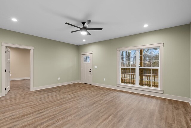 interior space featuring a ceiling fan, light wood-type flooring, baseboards, and recessed lighting