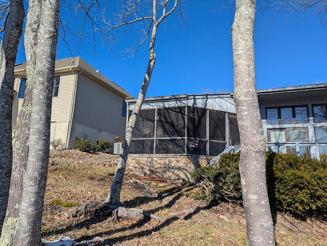 view of side of property with a sunroom