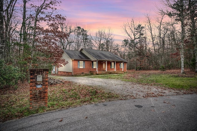 single story home featuring crawl space, driveway, and brick siding