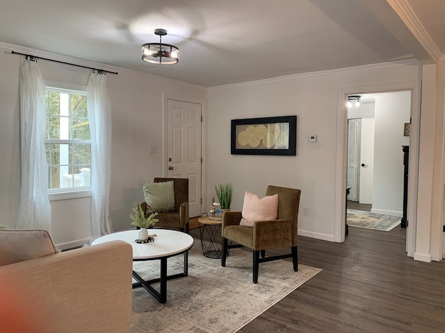 sitting room with ornamental molding, dark wood-style flooring, and baseboards