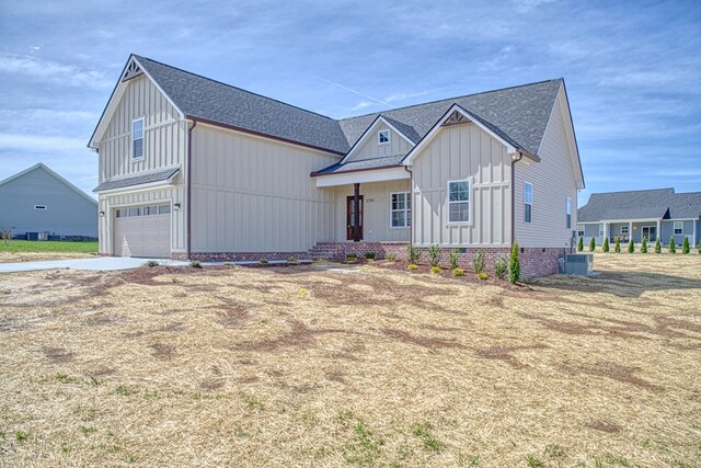 rear view of property with crawl space, roof with shingles, and a deck