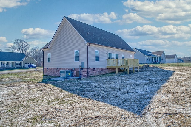 view of property exterior with central air condition unit, a shingled roof, a residential view, and a deck