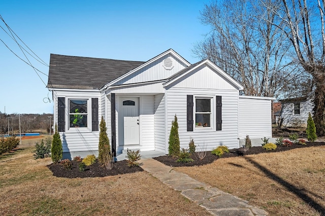 bungalow-style house featuring a front lawn