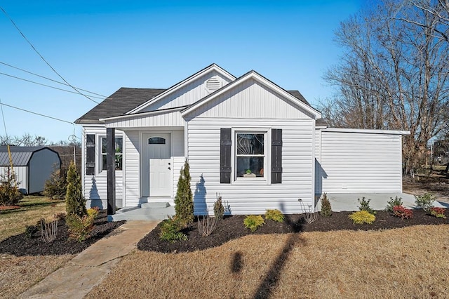 view of front of home featuring a storage shed and a front yard