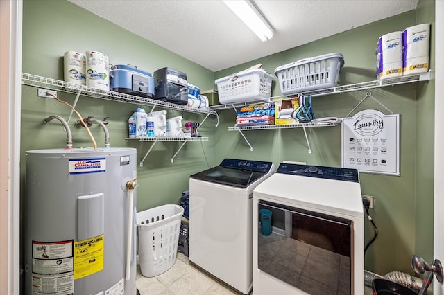 washroom with laundry area, electric water heater, a textured ceiling, and separate washer and dryer