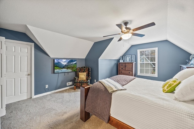 bedroom featuring baseboards, a ceiling fan, lofted ceiling, a textured ceiling, and carpet floors