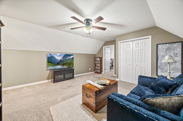 living room featuring light carpet, baseboards, ceiling fan, vaulted ceiling, and a textured ceiling