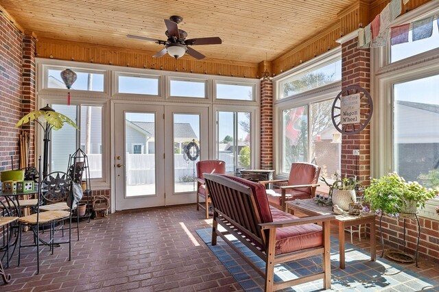 sunroom with ceiling fan and wooden ceiling