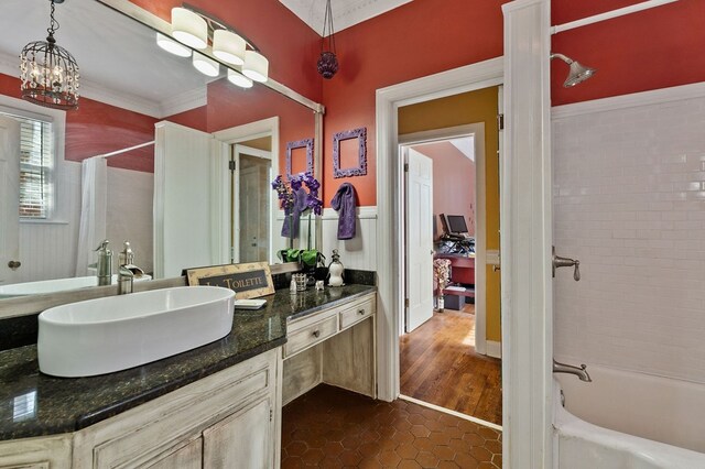 bathroom with tile patterned flooring, shower / bath combo with shower curtain, and vanity