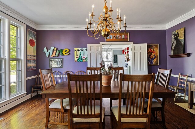 dining area featuring ornamental molding, an inviting chandelier, baseboards, and wood finished floors