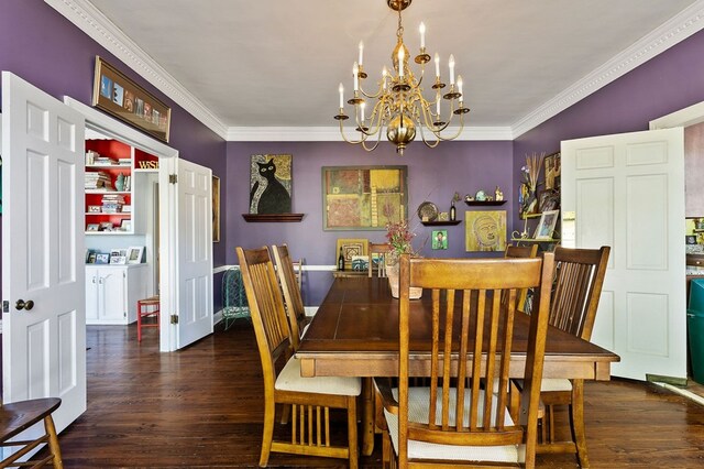 dining room featuring dark wood-style floors, ornamental molding, an inviting chandelier, and washing machine and clothes dryer