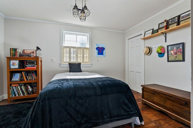 bedroom featuring ornamental molding and dark wood-style flooring