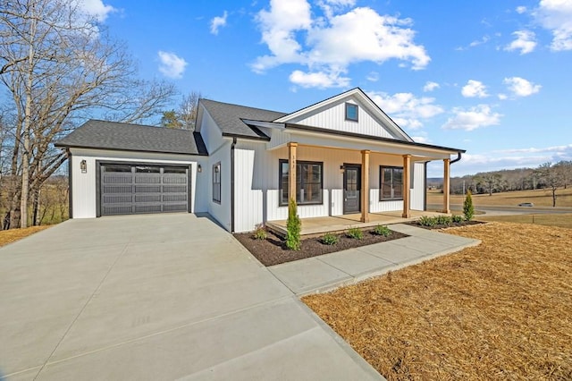 modern farmhouse featuring a garage, a shingled roof, a porch, and concrete driveway