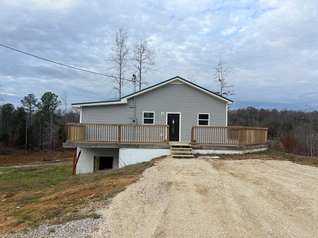 view of front of home with driveway and a deck