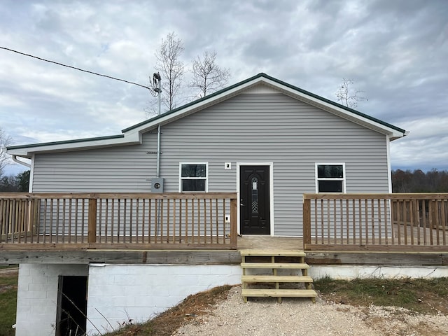 rear view of property featuring a deck