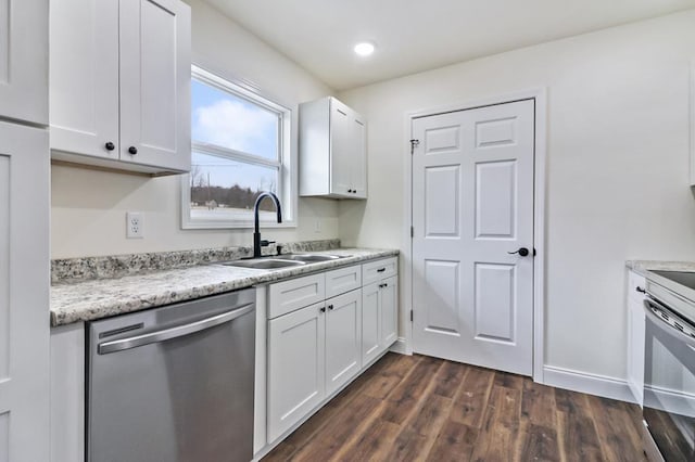 kitchen featuring baseboards, dark wood finished floors, white cabinets, appliances with stainless steel finishes, and a sink