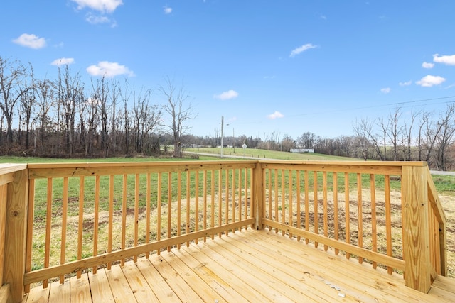 wooden terrace featuring a yard