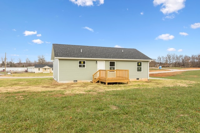 rear view of property with crawl space, a yard, roof with shingles, and a wooden deck