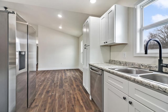 kitchen with appliances with stainless steel finishes, recessed lighting, white cabinets, and a sink