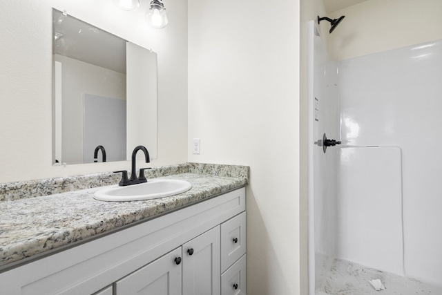 bathroom with a shower and vanity