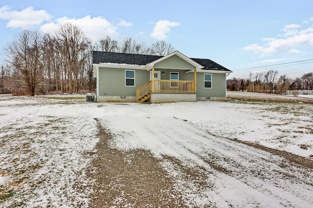 view of front of home featuring a shingled roof and crawl space