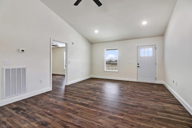 unfurnished living room with visible vents, dark wood-type flooring, vaulted ceiling, ceiling fan, and baseboards