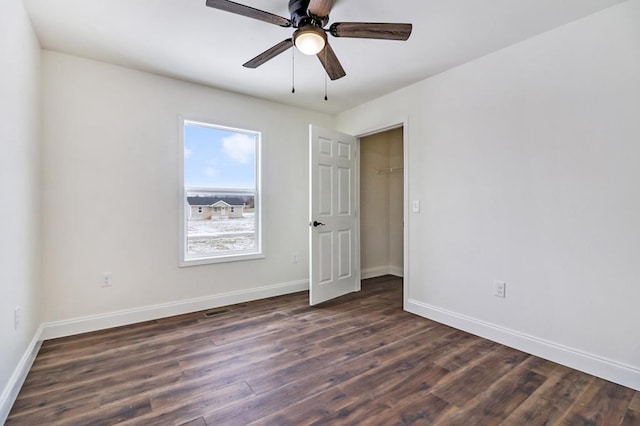 unfurnished bedroom with dark wood-style floors, ceiling fan, and baseboards