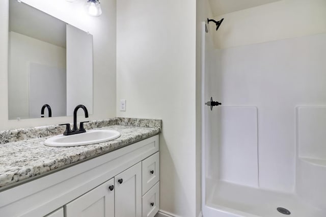 bathroom featuring vanity and walk in shower