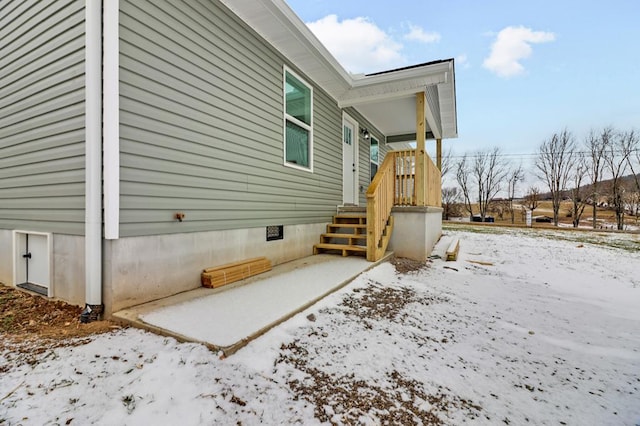 view of snow covered exterior with crawl space