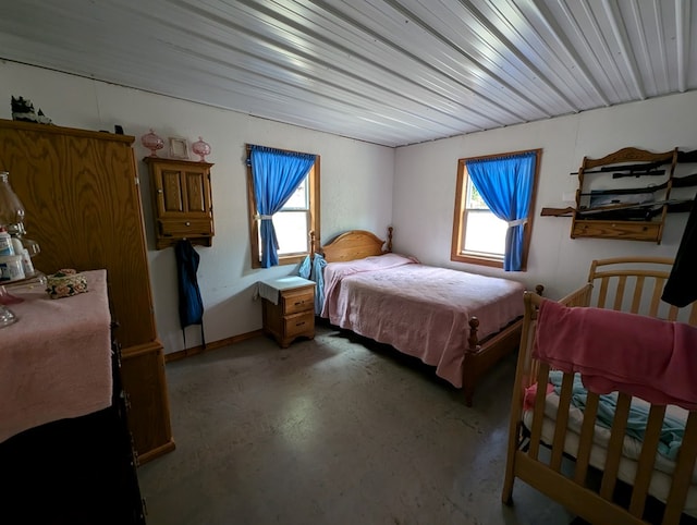 bedroom featuring concrete floors