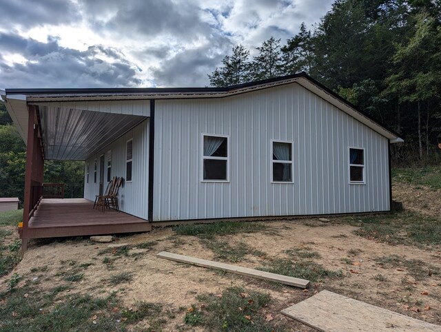 view of side of home with a wooden deck