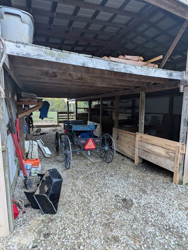 view of car parking with an attached carport and an exterior structure