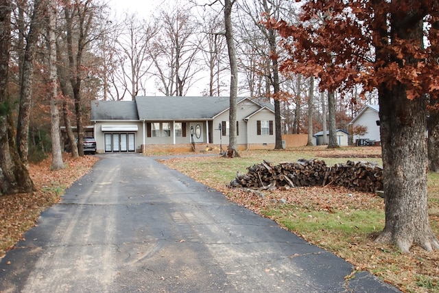 ranch-style house with driveway, french doors, and crawl space