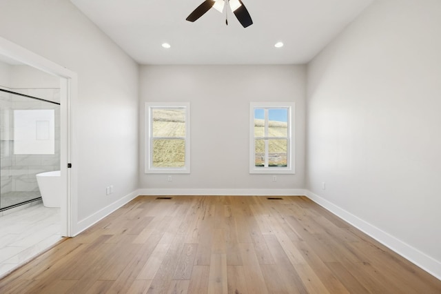 spare room with recessed lighting, baseboards, ceiling fan, and light wood finished floors